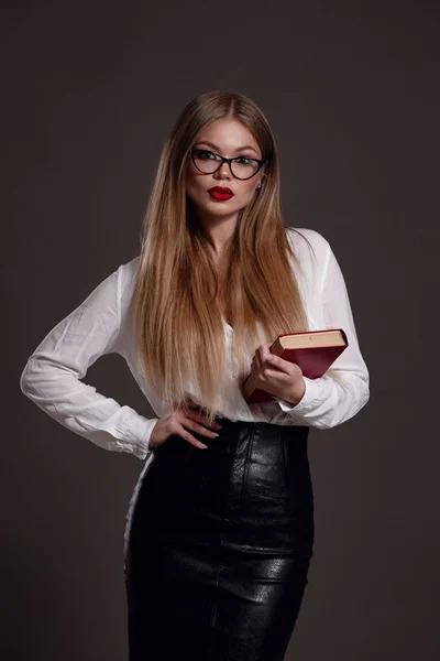 Studio portrait of young business woman with blonde hair in black suit — 스톡 사진