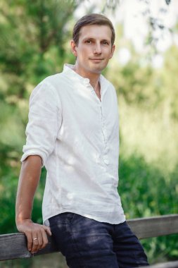 young courageous man in the summer garden.