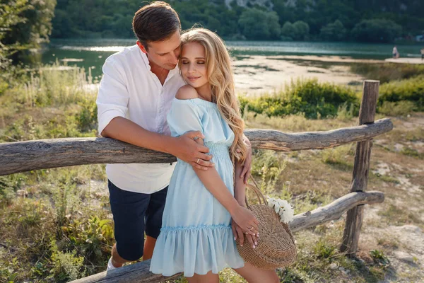 Lovers enjoy each other in the evening lake.