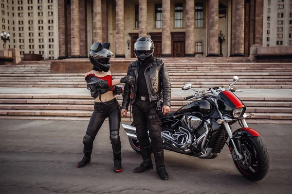 Beautiful couple on a cool motorcycle against Moscow — ストック写真