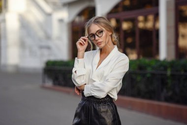 Young stylish woman walking on the street in Paris