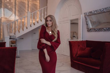 romantic portrait of elegand blond woman waiting for someone in a luxury restaurant