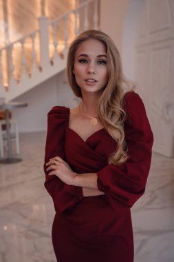 romantic portrait of elegand blond woman waiting for someone in a luxury restaurant