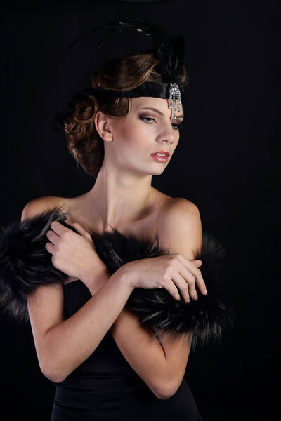Beautiful woman in the style of Art Nouveau, the era of gangsters. Fashion clothes, make-up and hair in luxurious retro style the roaring 20s.