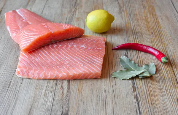 Fresh raw salmon fillet on a wooden background. Selective focus — 스톡 사진