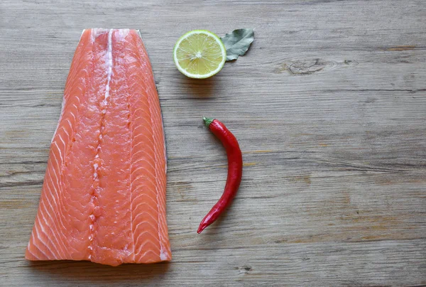 Fresh raw salmon fillet on a wooden background. Top view, selective focus. — 스톡 사진