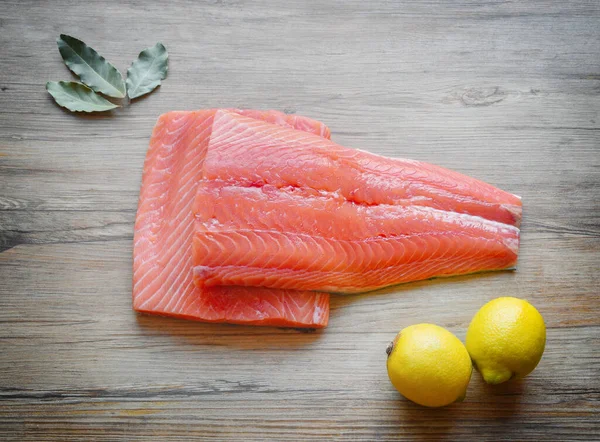 Fresh raw salmon fillet on a wooden background. Top view, selective focus. — 스톡 사진