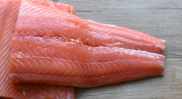 Fresh raw salmon fillet on a wooden background. Close up, top view. — 스톡 사진