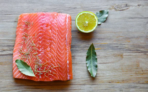 Fresh raw salmon fillet on a wooden background. Top view, selective focus. — 스톡 사진
