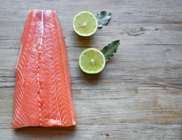 Fresh raw salmon fillet on a wooden background. Top view, selective focus. — 스톡 사진