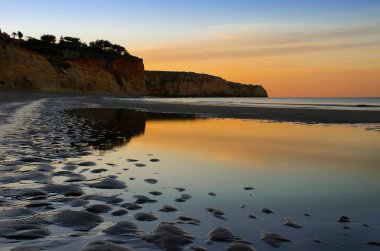 Yüksek kayalıklarla çevrili güzel Porto de Mos Sahili altın kumdan yapılmış uzun bir dil gibidir. Lagos, Batı Algarve kıyıları, Portekiz.