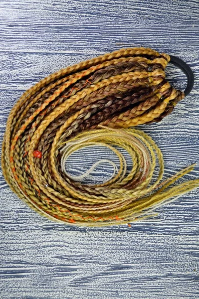 Blonde braids on a gray background at close range — Stock Photo, Image