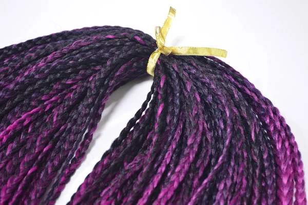 Pink braids on a white background at close range — Stock Photo, Image