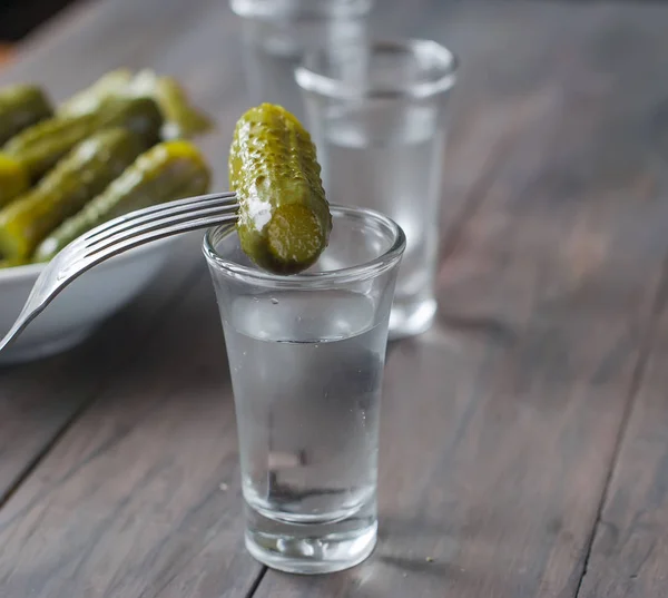 Small glass with Russian vodka and salt cucumber — Stock Photo, Image