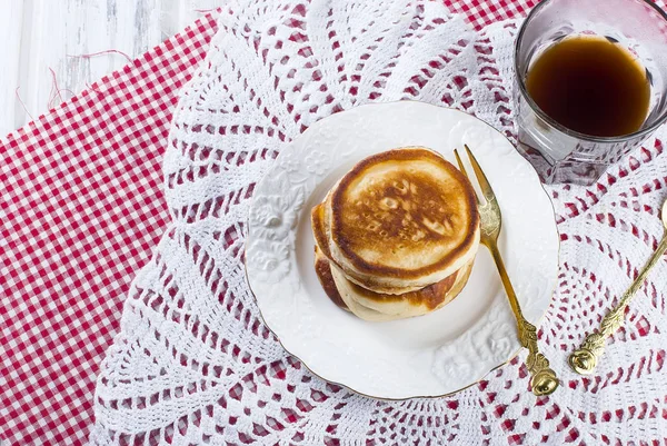 Stack of  pancakes in a dish on wooden white  background — Stock Photo, Image