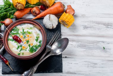 Mısır çorbası bir seramik tabak ve malzemeler