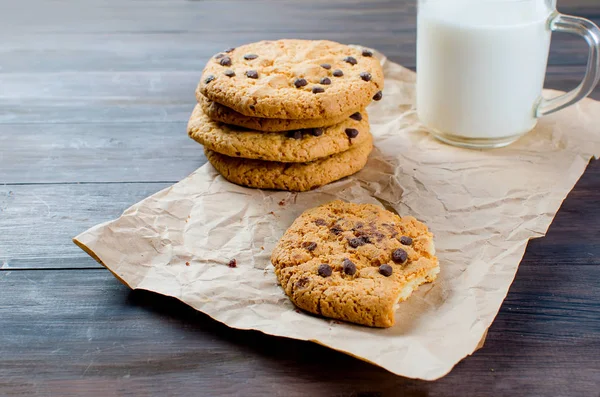 cookies with chocolate drops and a glass of milk