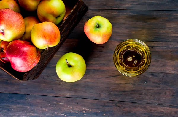 Jablečná šťáva v sklenici a pečená jablka na dřevěný stůl — Stock fotografie