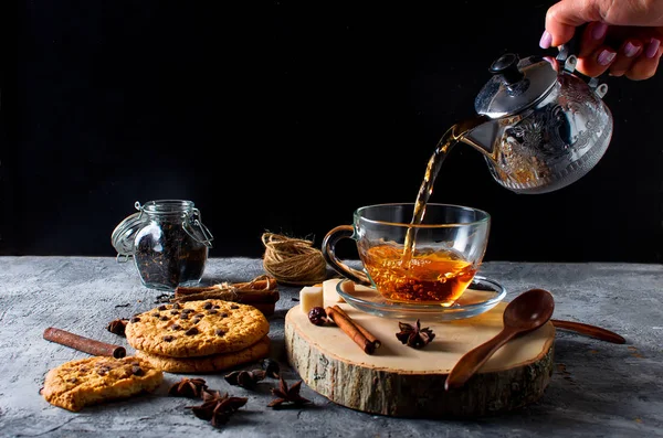 Cup of  tea, biscuits, cinnamon, anise on dark   background — Stock Photo, Image