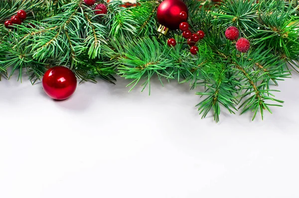 Рождественский фон с елкой, красным мячом и зимними ягодами — стоковое фото
