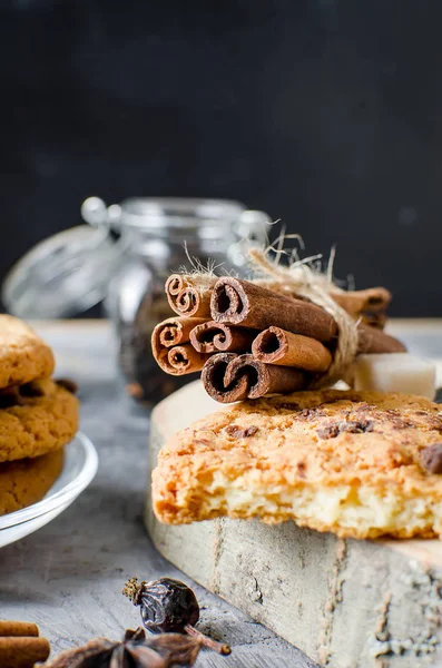 Sticks cinnamon, anise, biscuits  on dark   background — Stock Photo, Image