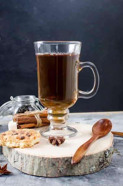 Чашка чая, печенья, корицы, аниса на тёмном фоне — стоковое фото