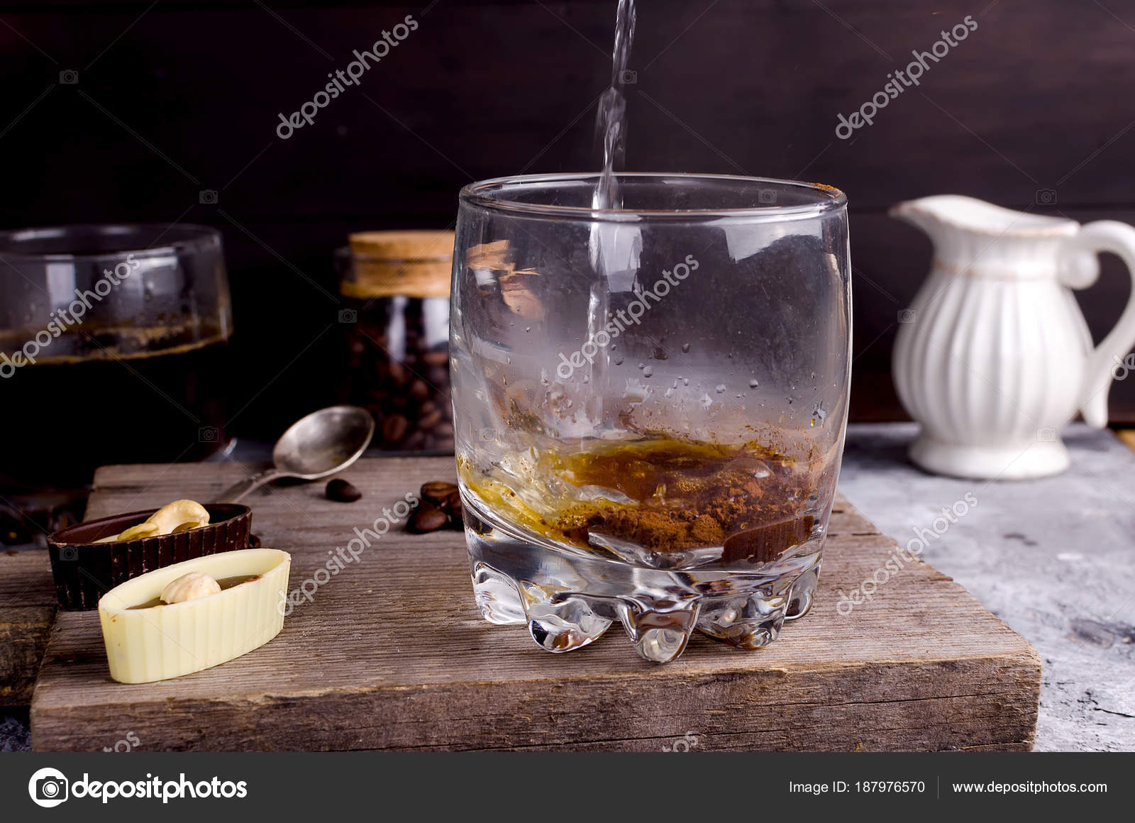 Pouring boiling water into a glass of coffee Stock Photo by ©vimart