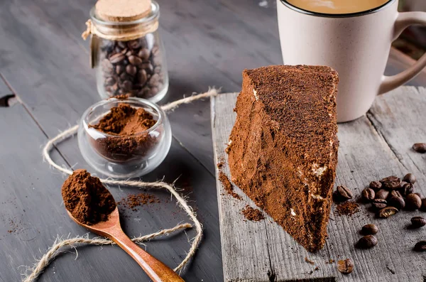 Cheese in ground coffee and a cup of cappuccino — Stock Photo, Image