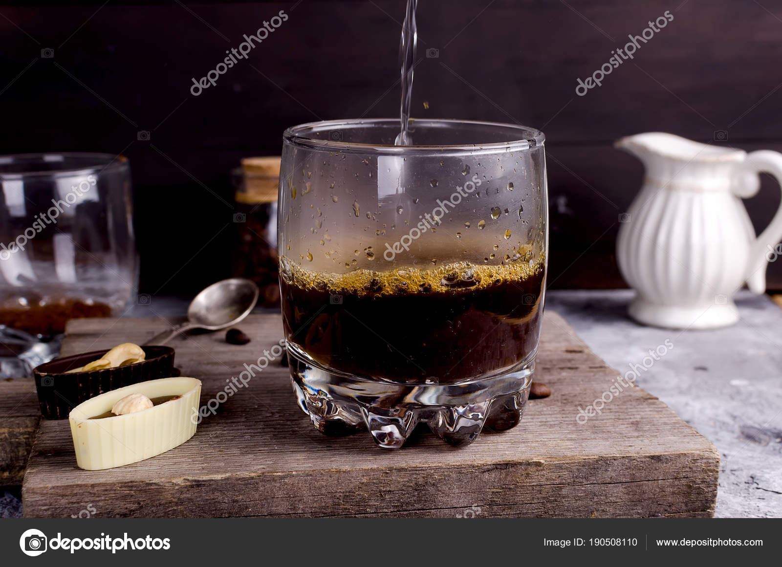 Pouring boiling water into a glass of coffee — Stock Photo © vimart