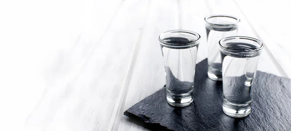 Vodka shots on white table. Banner. — Stock Photo, Image