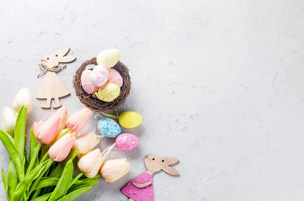 Fondo de Pascua con huevos decorativos de colores en el nido y t — Foto de Stock