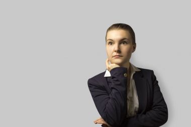 portre vurdu. bir ceket giyen genç güzel iş kadın geri, taranmış kısa saçlı. ciddi bir yüz ile