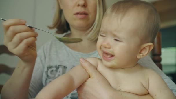 Joven madre cuchara alimentación su bebé niña — Vídeos de Stock