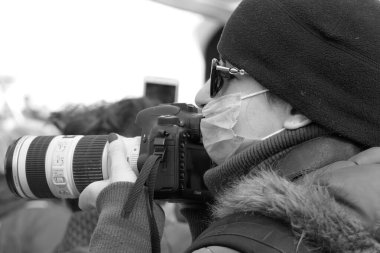 Kiev, Ukraine - March, 16, 2020: a woman with a camera and a mask.