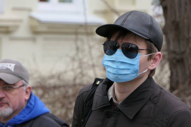 Kiev, Ukraine - March, 16, 2020: a stylish masked guy is the hit of the season.