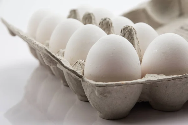 white chicken eggs on a white background