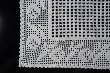 Tığ işi peçeteler, siyah arka planda beyaz dantel.