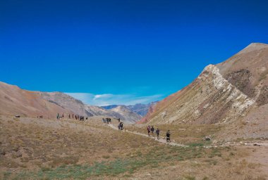 MENDOZA, ARGENTINA - NOVEMBER 17, 2019: Tourists walk through trail to the Aconcagua mountain viewpoint in Mendoza, Argentina