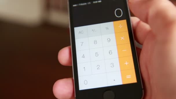 Man Is Making Arithmetic Operation With The Calculator Of The Smartphone — Video