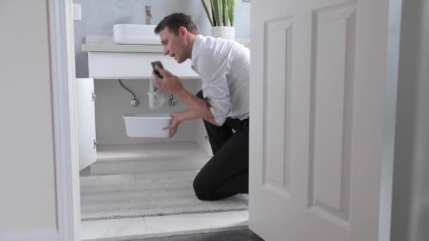 Man Calling Emergency Plumber Water Leak Bathroom Home Man Home — Stock Video