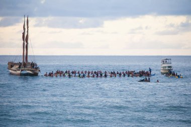OAHU, HI - December 5, 2013: The 29th annual Quiksilver in Memory of Eddie Aikau, big wave surfing tournament held at Waimea Bay. The tournament is named for native Hawaiian, champion big wave surfer Eddie Aikau. clipart