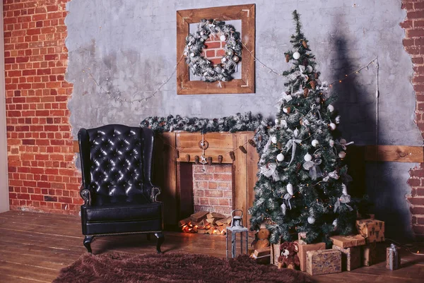 Beautiful modern design of the room in dark colors, decorated with a Christmas tree and New Year\'s decorative elements