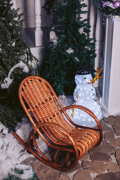 Wicker rattan chair, in a Christmas interior with a snowman — Stock Photo, Image