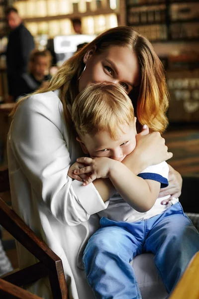 Cute Young Mother Hugs Little Son While Sitting Cafe Child — Stock Photo, Image