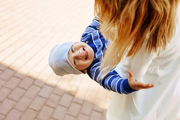 Young Mother White Coat Circling Little Son Her Arms While — Stock Photo, Image