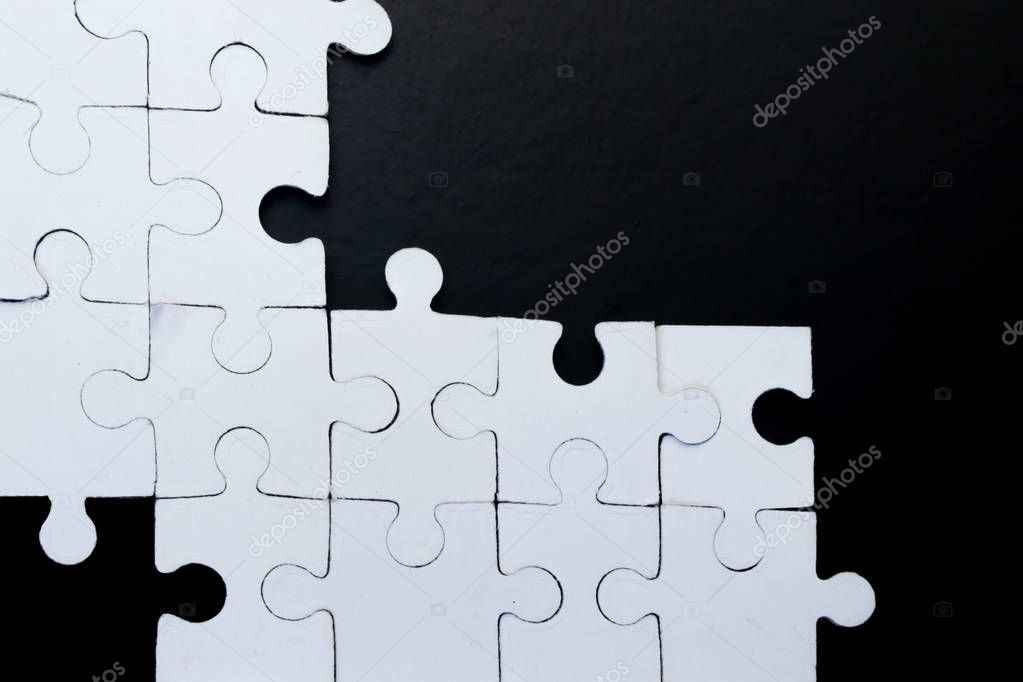 White puzzles on a black background