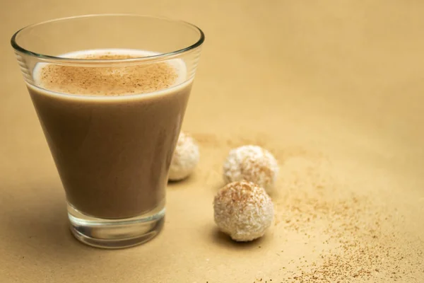 Cocoa milk in a glass, white truffles