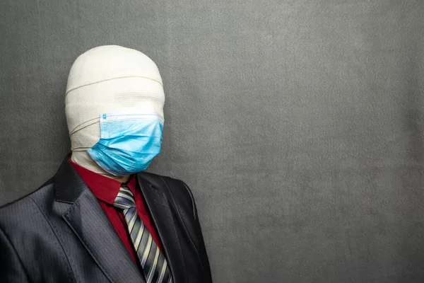 Incognito man in a medical mask is dressed in a business suit