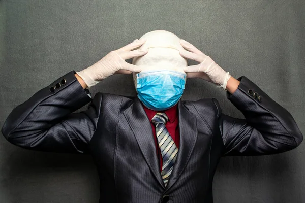 Incognito man in a medical mask is dressed in a business suit