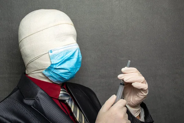 Incognito man in a medical mask is dressed in a business suit